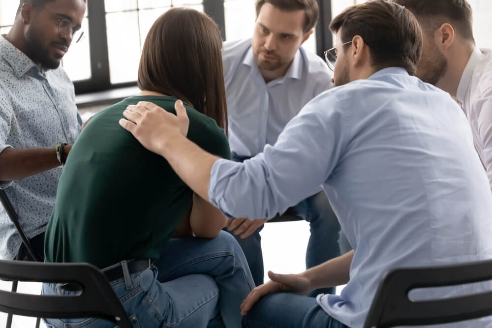 Group of individual talking and consoling each other